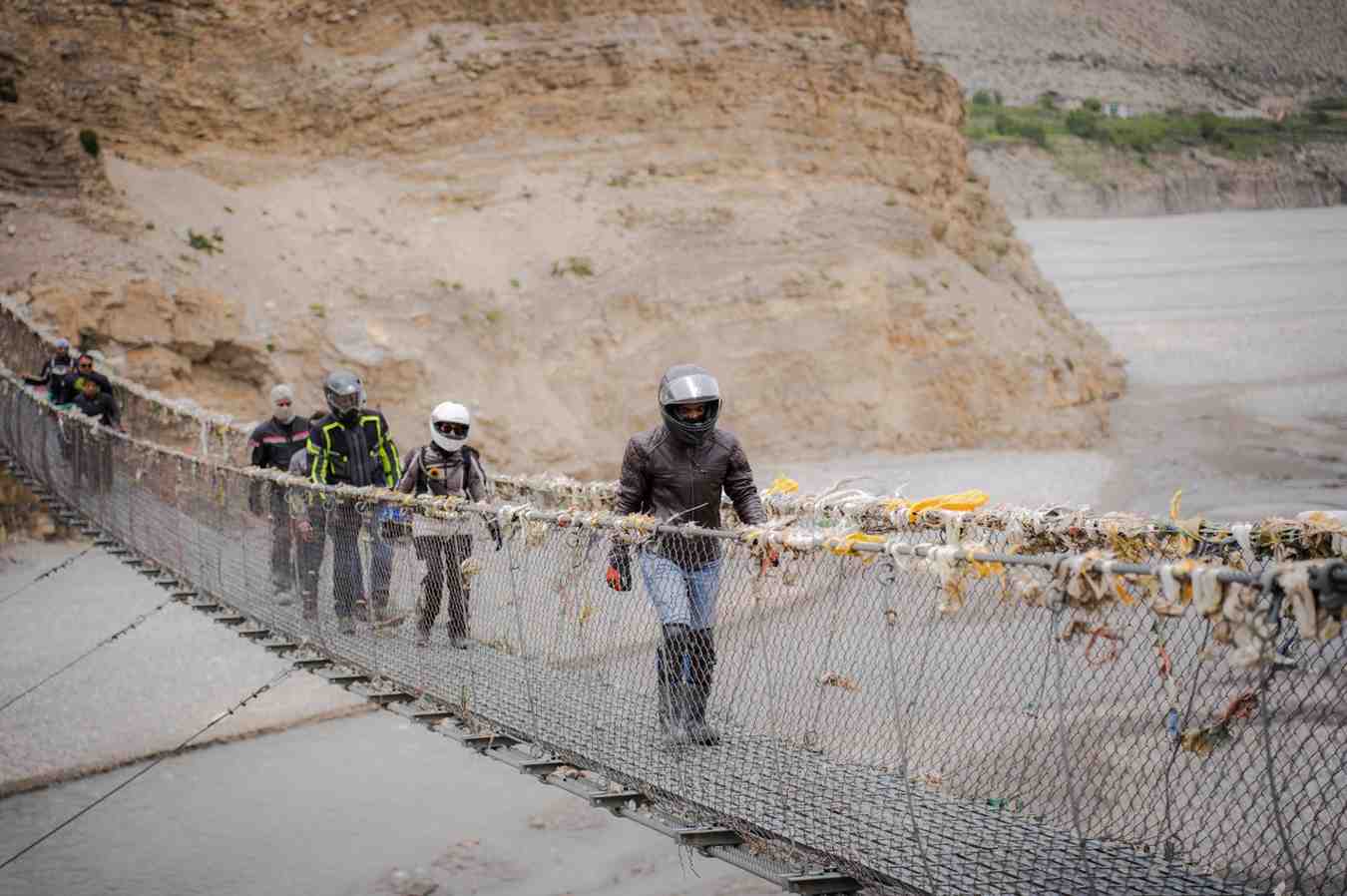 202606281937_riders-group-walking-through-suspension-bridge-in-muktinath.jpg
